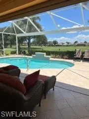 View of swimming pool featuring a patio area and a lanai