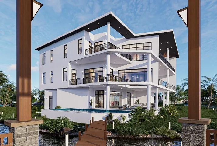 Back of house featuring a balcony, a patio area, stucco siding, and an outdoor pool