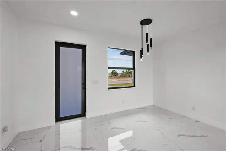 Empty room with recessed lighting, baseboards, and marble finish floor