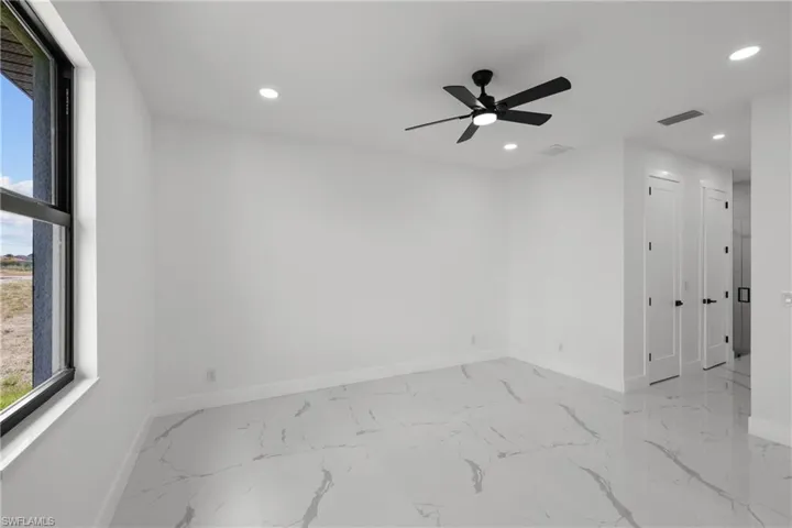 Spare room with visible vents, recessed lighting, marble finish floor, and baseboards