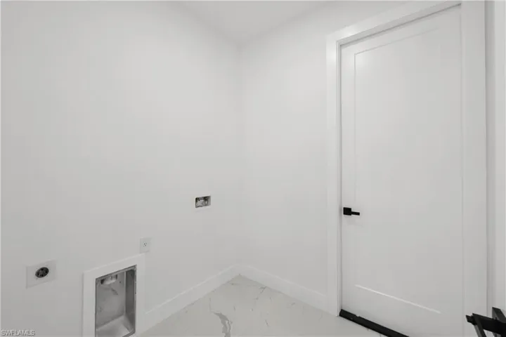 Washroom featuring laundry area, electric dryer hookup, baseboards, hookup for a washing machine, and marble finish floor