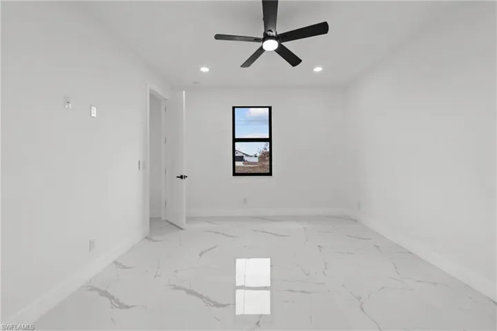 Empty room featuring recessed lighting, baseboards, and marble finish floor