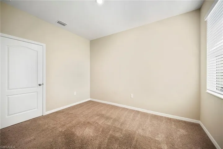 Unfurnished bedroom featuring carpet and baseboards