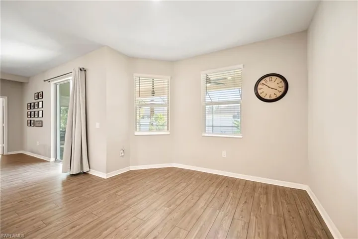 Empty room with baseboards and light wood-type flooring