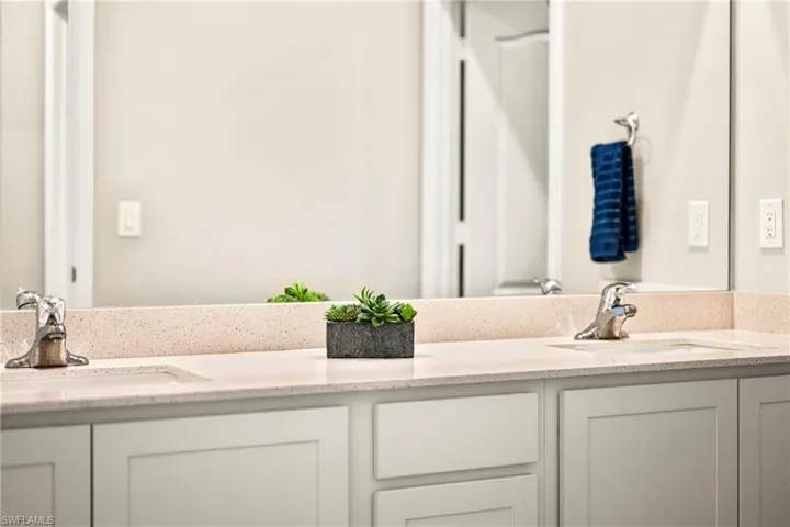 Full bath featuring double vanity