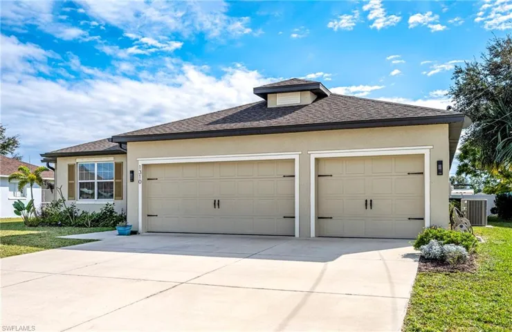 View of front of property with stucco siding, a shingled roof, driveway, and an attached garage