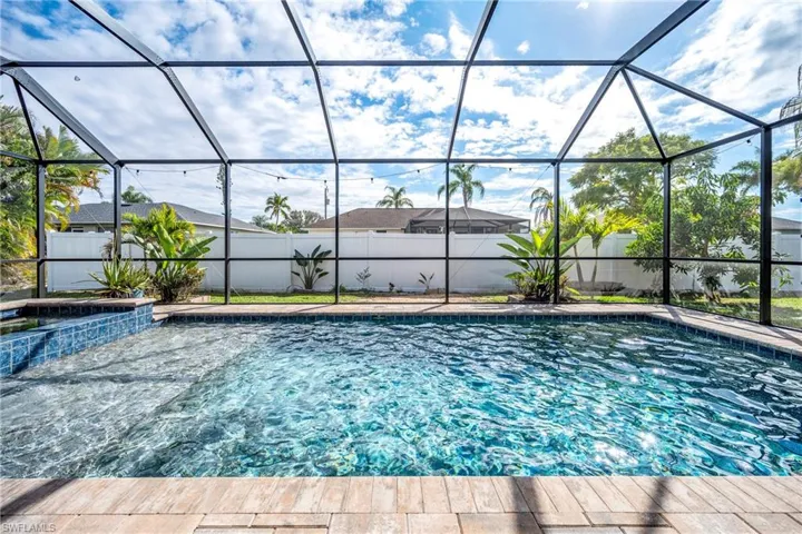 Combined pool / hot tub featuring a sunroom, glass enclosure, and a fenced backyard
