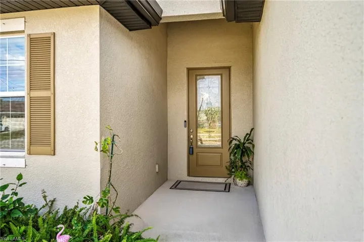 View of exterior entry with stucco siding