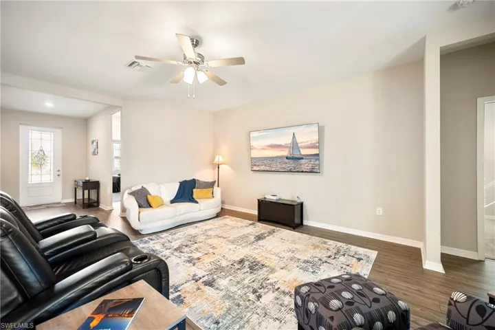 Living area featuring ceiling fan and wood finished floors