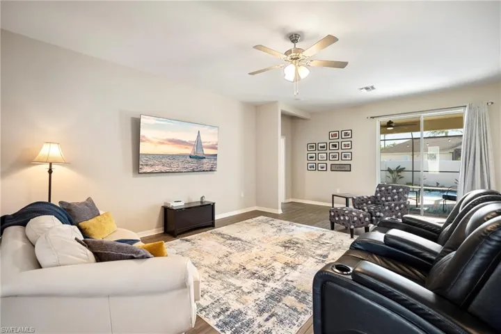 Living room with wood finished floors and a ceiling fan
