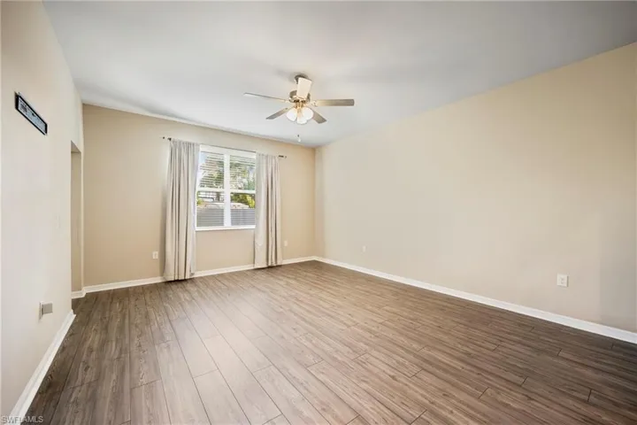 Empty room featuring ceiling fan and wood finished floors
