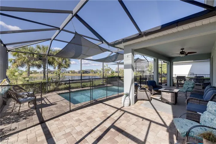 View of pool with a water view, an outdoor living space