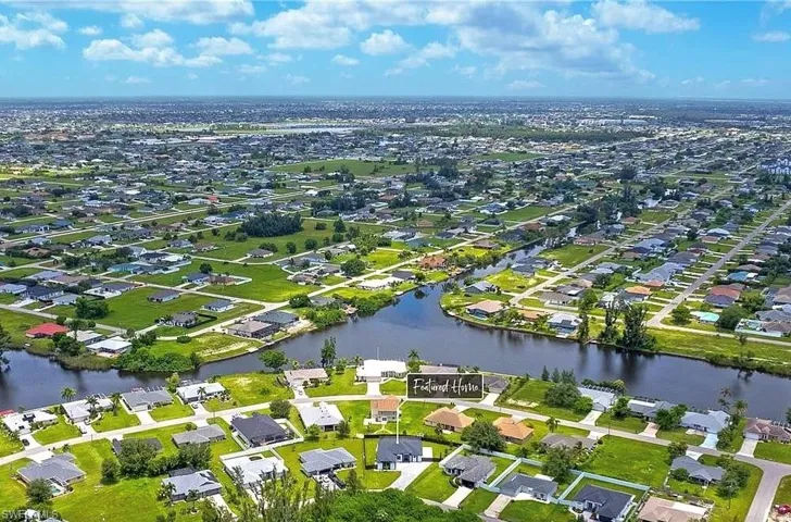 Aerial view of property's location featuring nearby suburban area and a nearby body of water