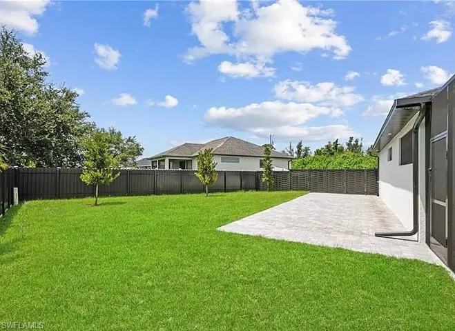 Fenced backyard with a patio area