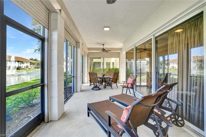 L-shaped Lanai with fully pocketing doors overlooking lake