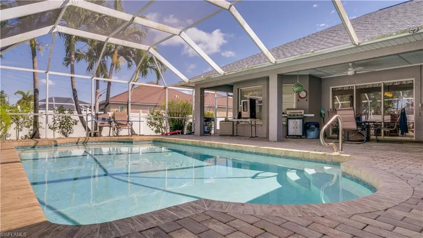 View of swimming pool with glass enclosure, a fenced in pool, outdoor dining area, ceiling fan, and a patio area