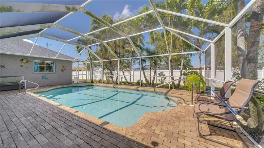 View of pool featuring a lanai, a fenced in pool, a fenced backyard, and a patio area