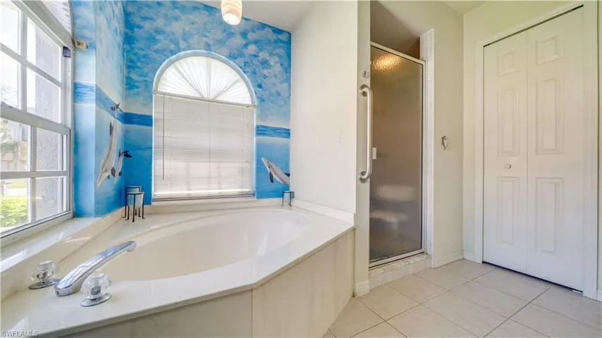 Full bath with a shower stall, wallpapered walls, a closet, a garden tub, and tile patterned floors