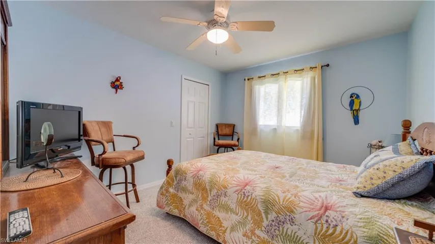 Bedroom featuring a closet, ceiling fan, baseboards, and carpet