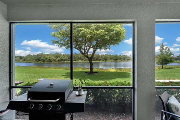 Screened outdoor space with water frontage and verdant landscaping