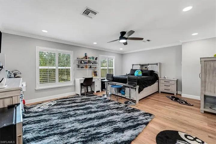 Wood-finish flooring, recessed lighting, and a ceiling fan