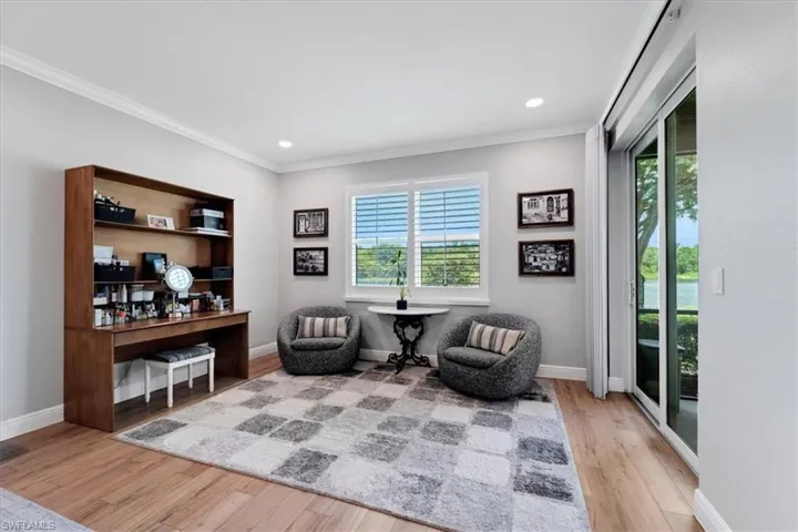 Wood-finish flooring with crown molding and recessed lighting