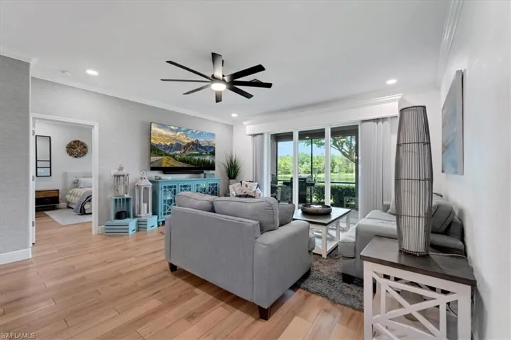 Wood-finish flooring throughout, crown molding, recessed lighting, and a contemporary ceiling fan