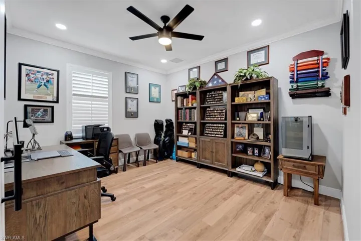 Recessed lighting, crown molding, wood-finish flooring, plantation shutters, and a ceiling fan