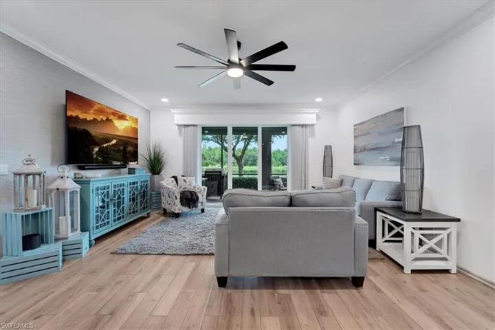 Wood-finish flooring throughout, complemented by a contemporary ceiling fan with integrated lighting