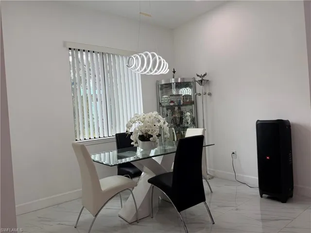 Dining room featuring light marble finish flooring