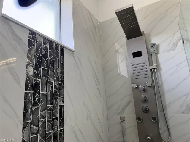 Bathroom with a marble finish shower