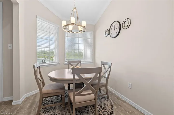 Kitchen featuring a sink, open floor plan, dishwasher, and light countertops