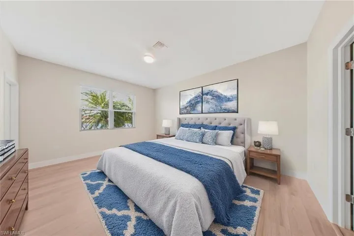 Virtual staging-Bedroom featuring light wood-type flooring and baseboards