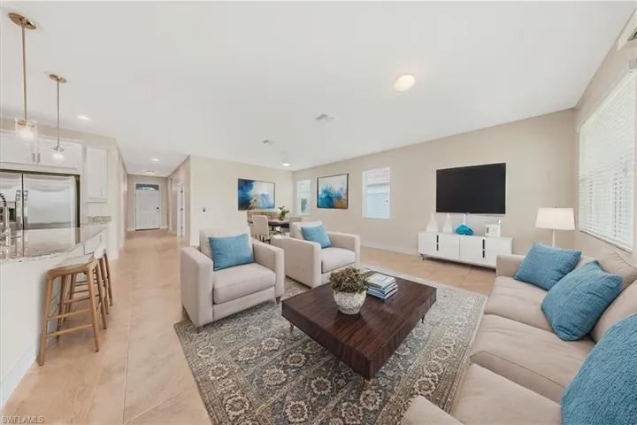 Virtual Staging-Living area featuring light tile patterned floors and baseboards