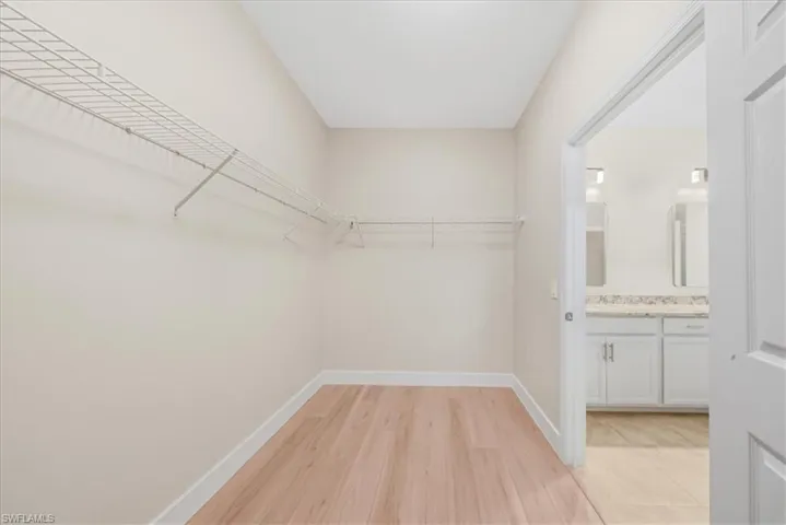 Walk in closet featuring light wood-style floors