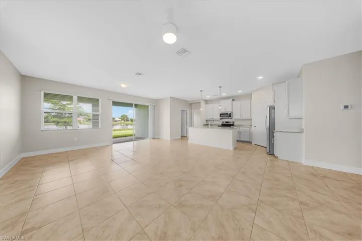 Unfurnished living room with recessed lighting and light tile patterned floors