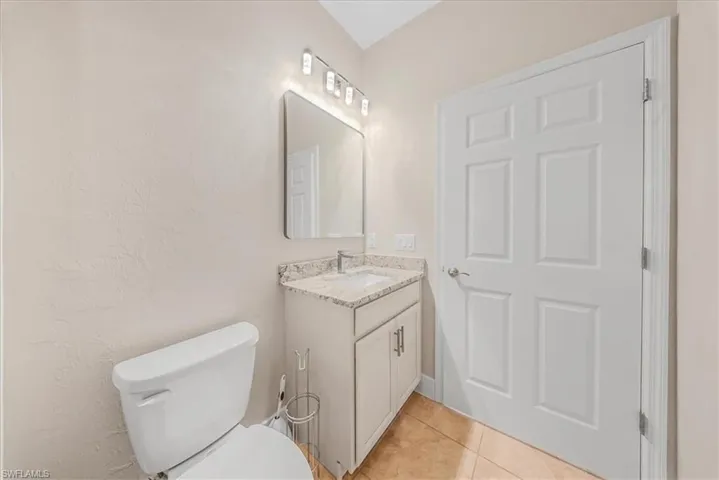Bathroom featuring light tile patterned flooring and vanity