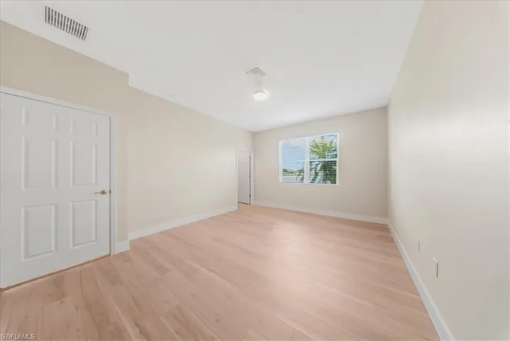 Unfurnished bedroom with baseboards and light wood-style floors