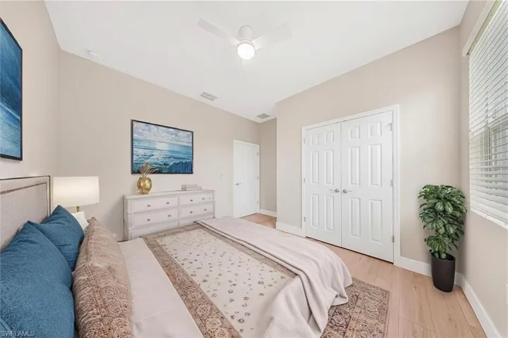 Virtual staging-Bedroom with light wood-type flooring, a ceiling fan, and a closet