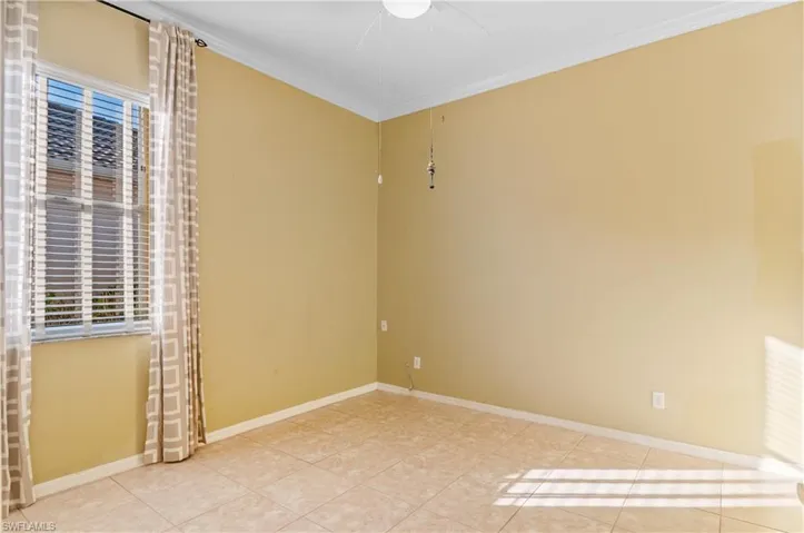 3rd Bedroom with crown molding, light tile patterned flooring, and ceiling fan
