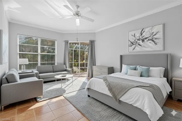 Virtually staged primary bedroom featuring crown molding, tile patterned floors, and a ceiling fan