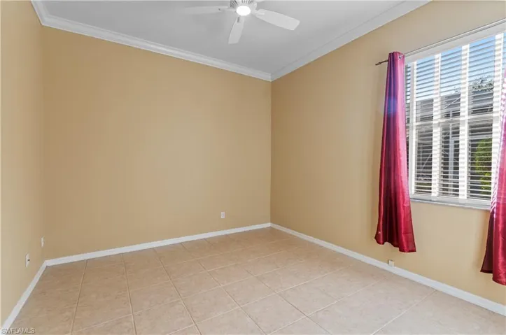 4th Bedroom featuring crown molding, a ceiling fan, and light tile patterned flooring