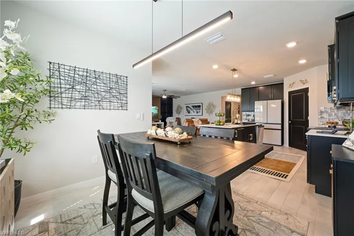 Dining room with a chandelier, recessed lighting, and a ceiling fan