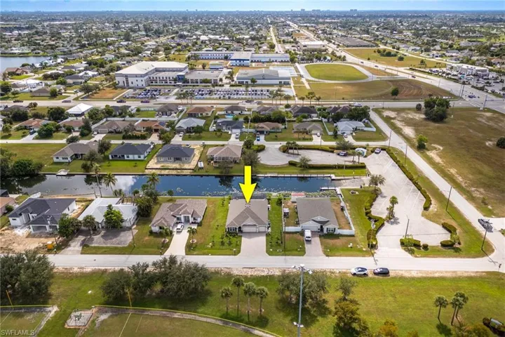Aerial overview of property's location featuring a large body of water and nearby suburban area