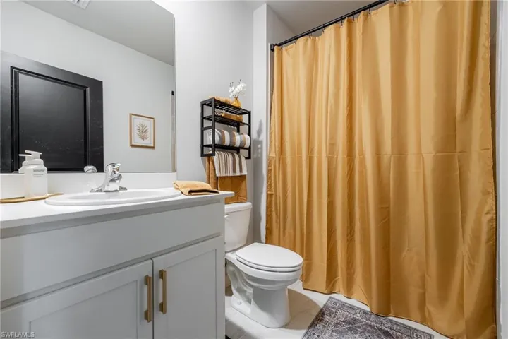 Full bath with vanity and a shower with curtain