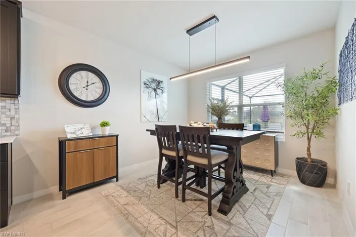 Dining room with light wood finished floors and baseboards