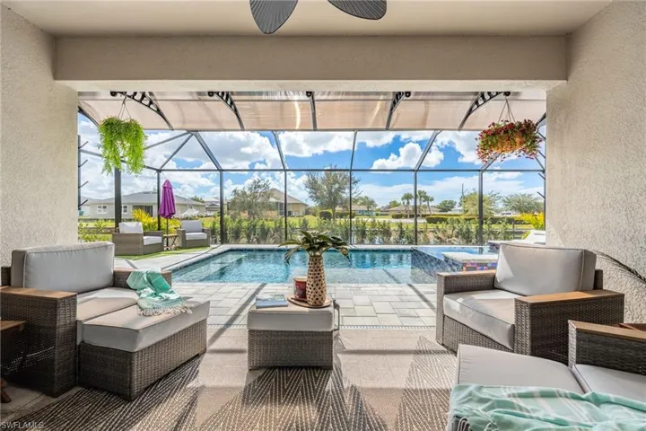 Outdoor pool with an outdoor hangout area, a sunroom, a lanai, and a patio