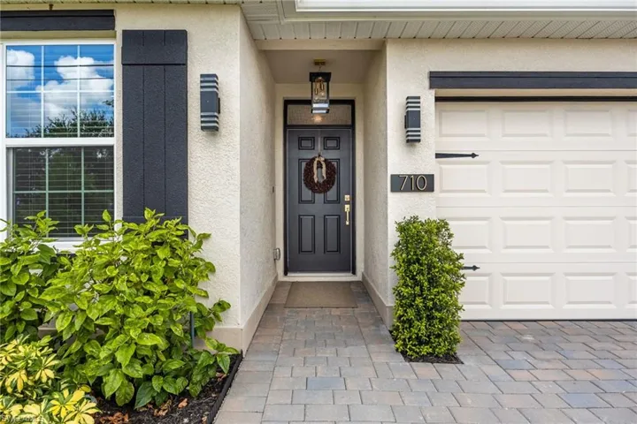 Entrance to property featuring stucco siding and a garage