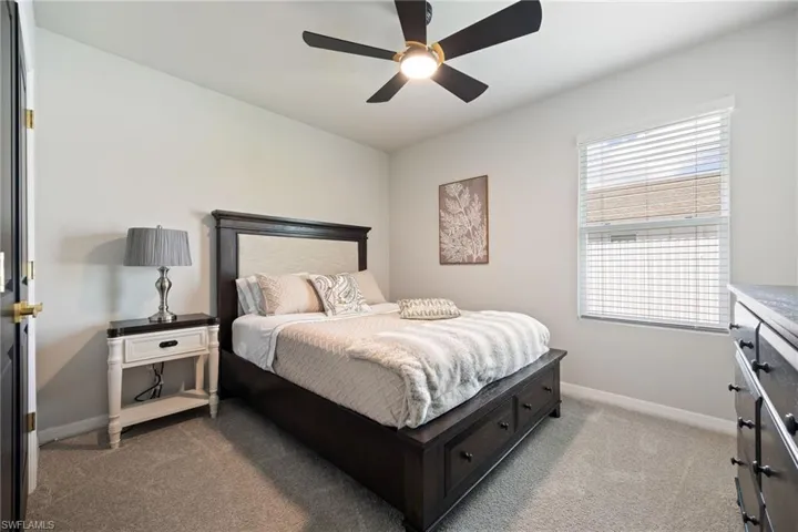 Bedroom featuring light carpet and ceiling fan