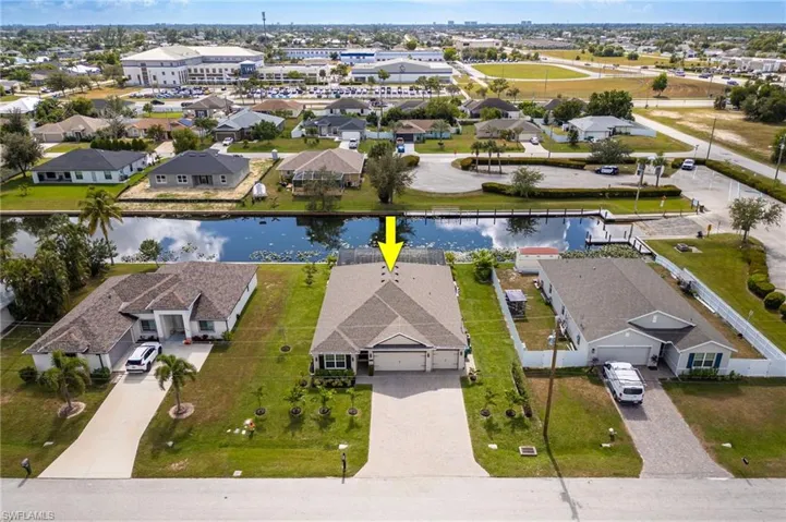 Aerial perspective of suburban area featuring a large body of water